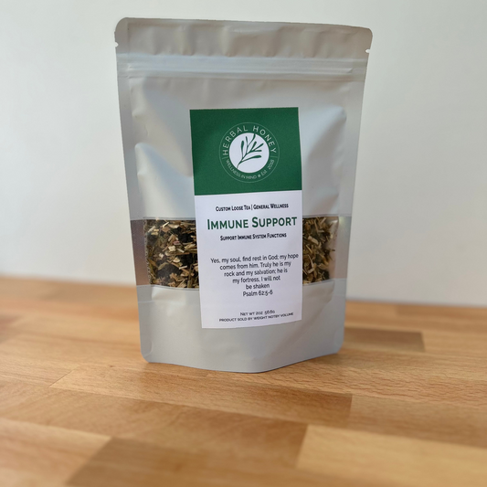 Package of immune support tea on a wooden surface with a white background