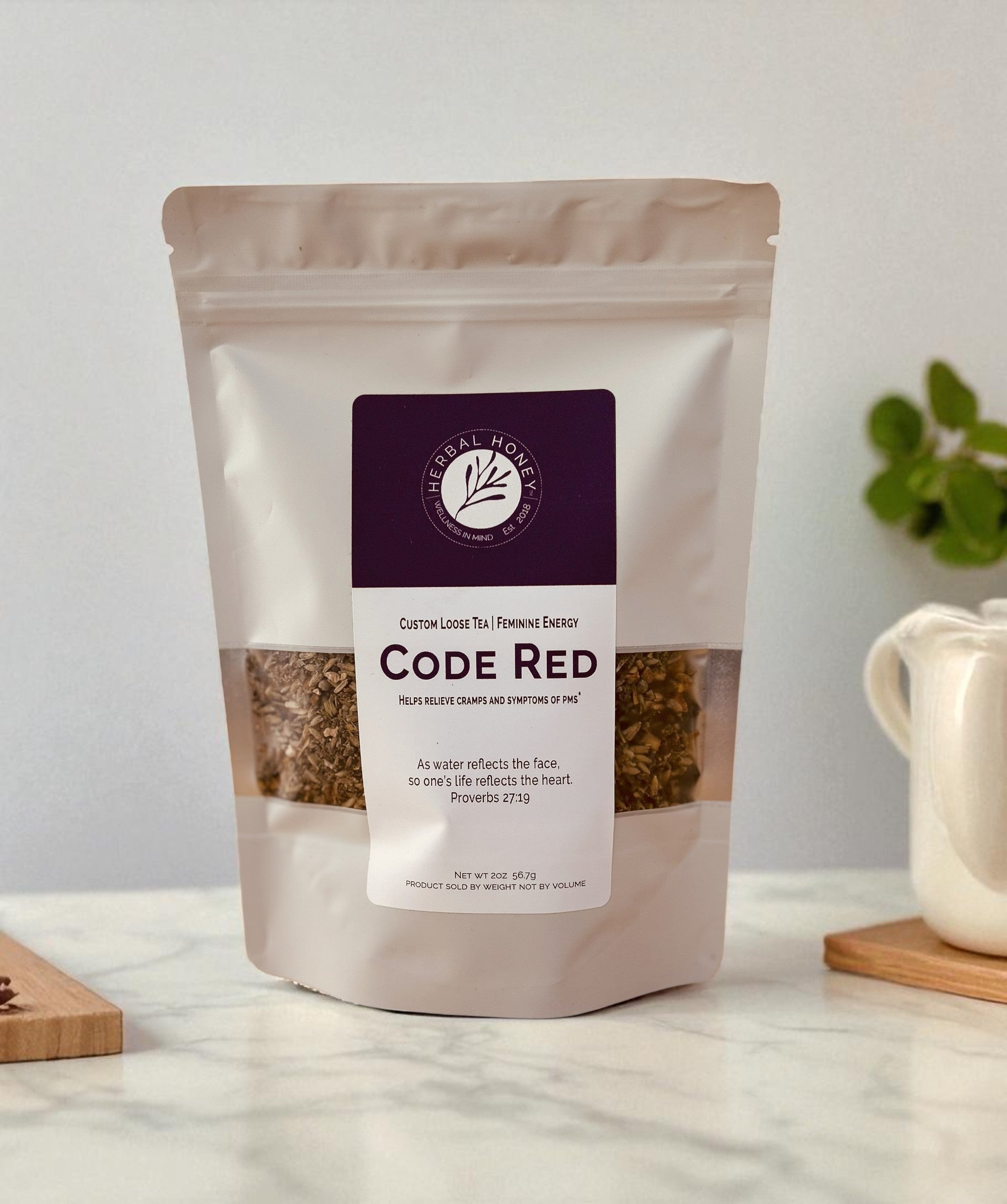 Tea package labeled 'Code Red' on a marble surface with a blurred background